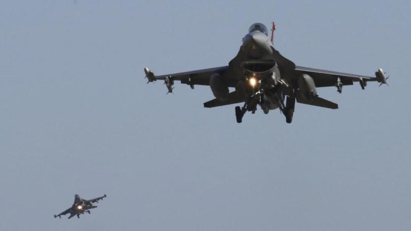 US air strikes have targeted members of the Islamic State group, officials say.