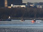 Emergency response units search the crash site near Reagan National Airport last week. MUST CREDIT: Astrid Riecken for The Washington Post