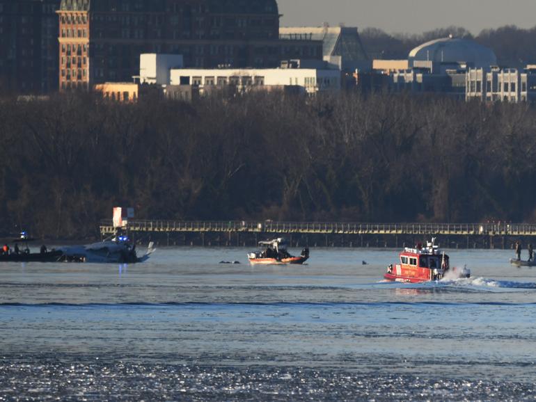 Emergency response units search the crash site near Reagan National Airport last week. MUST CREDIT: Astrid Riecken for The Washington Post