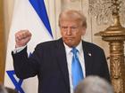 United States President Donald Trump puts his fist into the air following the press conference where he touted a plan for the US to takeover the Gaza strip. 