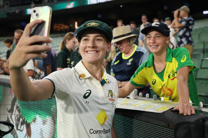 Annabel Sutherland taking a selfie with fans at the MCG.