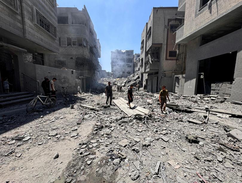 Palestinians search for casualties at the site of Israeli strikes on houses, amid Israel-Hamas conflict.