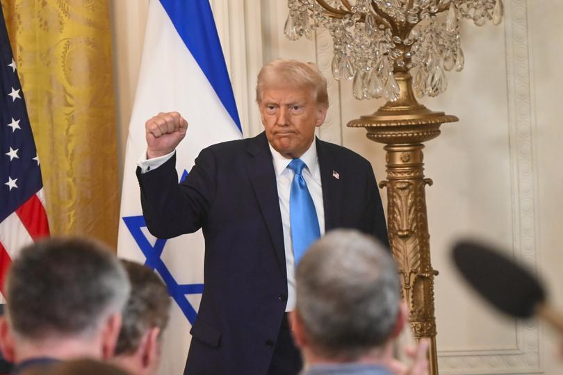 WASHINGTON D.C., UNITED STATES - FEBRUARY 04: United States President Donald Trump puts his fist into the air following a joint press conference with Israeli Prime Minister Benjamin Netanyahu (not seen) in the East Room at the White House in Washington, D.C., United States on February 04, 2025. (Photo by Kyle Mazza/Anadolu via Getty Images)