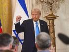 President Donald Trump puts his fist into the air following a joint press conference with Israeli Prime Minister Benjamin Netanyahu.