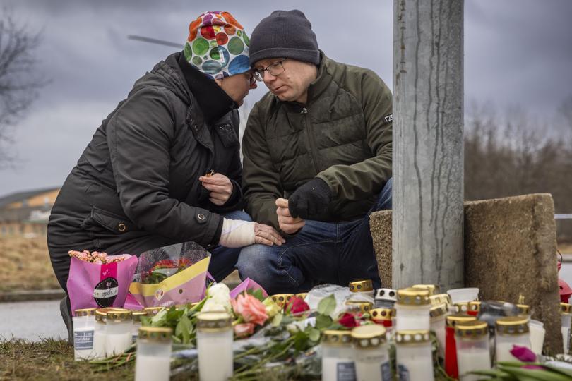 Mourners gather at Orebro, Sweden, to pay tribute to the victims.