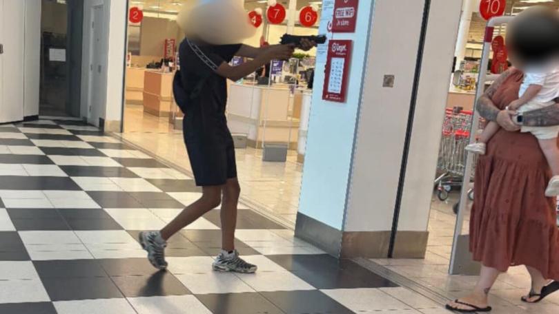 One of the teenagers was seen pointing a fake gun at a mother and her baby at a Target store in the shopping centre.