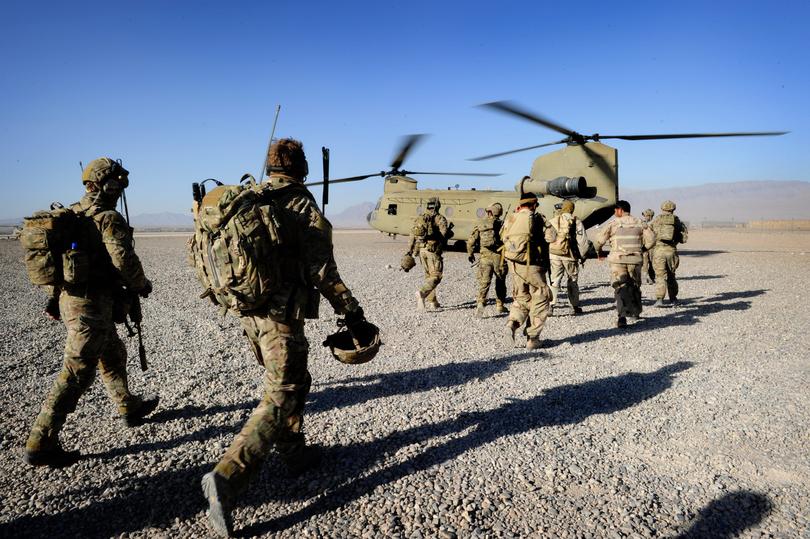 Australian troops from Special Operations Task Group and their Afghan counterparts from the Provincial Response Company - Uruzgan move towards a CH-47 Chinook aircraft ahead of a mission.