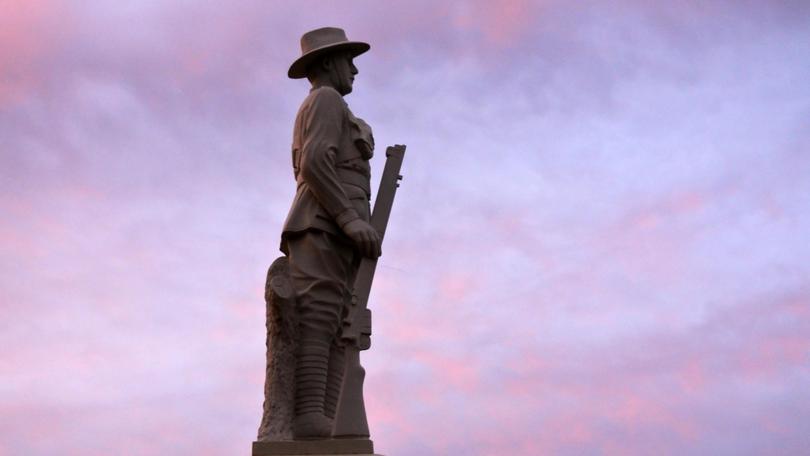 Silhouette of Aussie soldier keep silent against dramatic sunset sky with clouds in the outback of Queensland, Australia. Rafael Ben-Ari