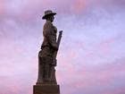 Silhouette of Aussie soldier keep silent against dramatic sunset sky with clouds in the outback of Queensland, Australia. Rafael Ben-Ari