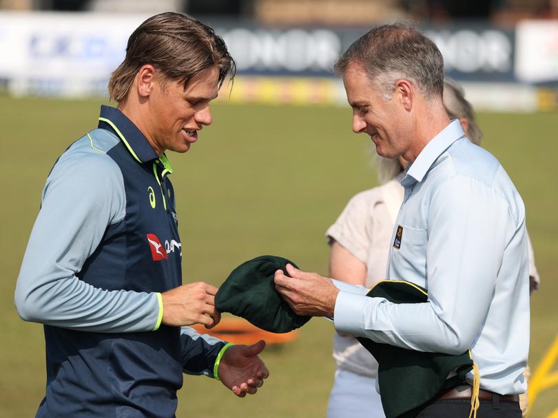 Connolly gets his baggy green from Simon Katich.