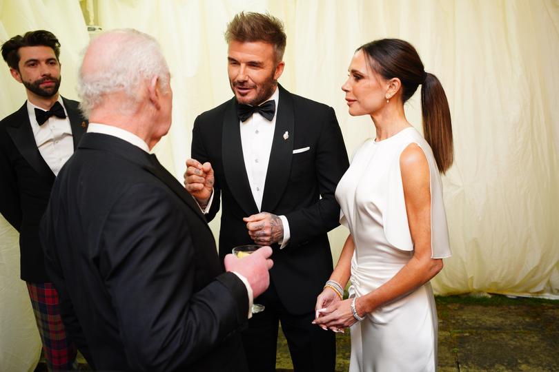 King Charles III speaks to David Beckham and Victoria Beckham.