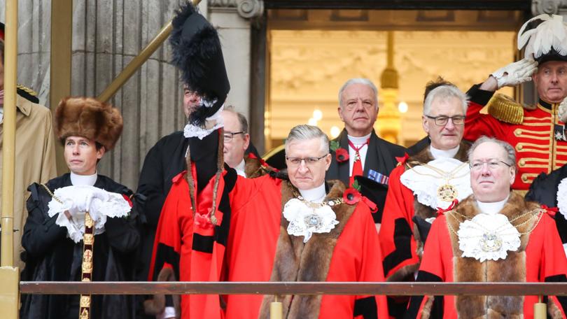 Alastair King (front” the 696th Lord Mayor of London, waves to crowds during the Lord Mayor's Show in London.