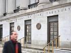 A man walks past the US Treasury in Washington, DC, on February 6, 2025. Opponents to US President Donald Trump say he allowed Elon Musk -- the world's richest man and a major government contractor -- to break the law by accessing US Treasury payment systems that send out trillions of dollars and hold a welter of sensitive personal data. (Photo by Mandel NGAN / AFP)