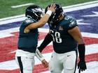 Jalen Hurts celebrates a touchdown with Jordan Mailata.