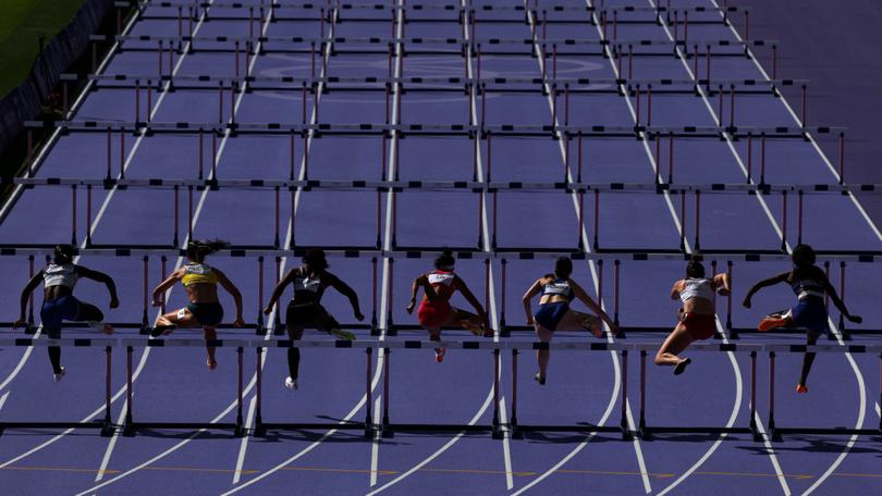 Athletes competing in the Women's 100m Hurdles Repechage at the Paris Olympics.