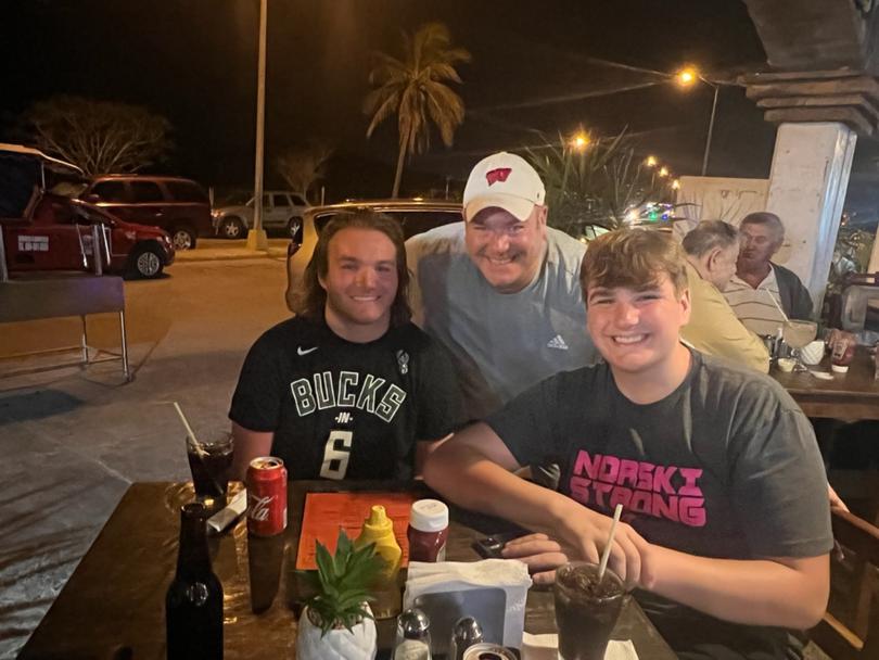 Cole Schmidtknecht, left, with his father and younger brother, Dane