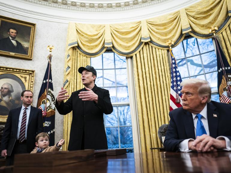 Elon Musk, with his son X Æ A-Xii, speaks with President Donald Trump and reporters in the Oval Office at the White House on Tuesday. 