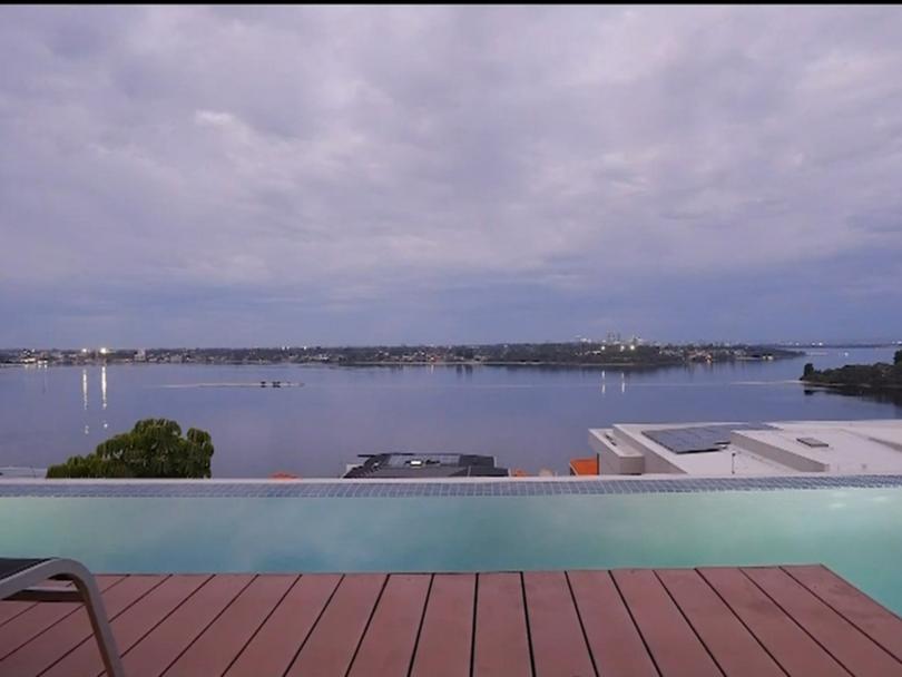 The modern mansion sits by the Swan River.