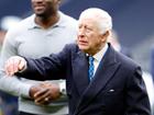 King Charles III reacts after throwing an American football in London.