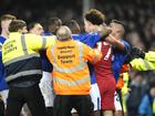 Liverpool's Curtis Jones (centre) and Everton's Abdoulaye Doucoure are separated by teammates.