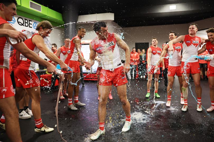 Caiden Cleary of the Swans celebrates victory with teammates after his debut. 