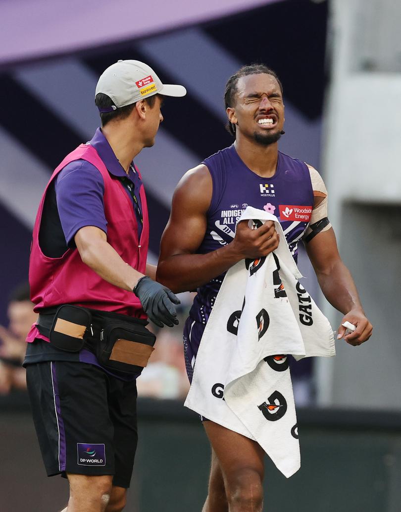 Fremantle's Brandon Walker leaves the field with a facial injury.