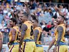 The Indigenous All Stars players performing their war cry.