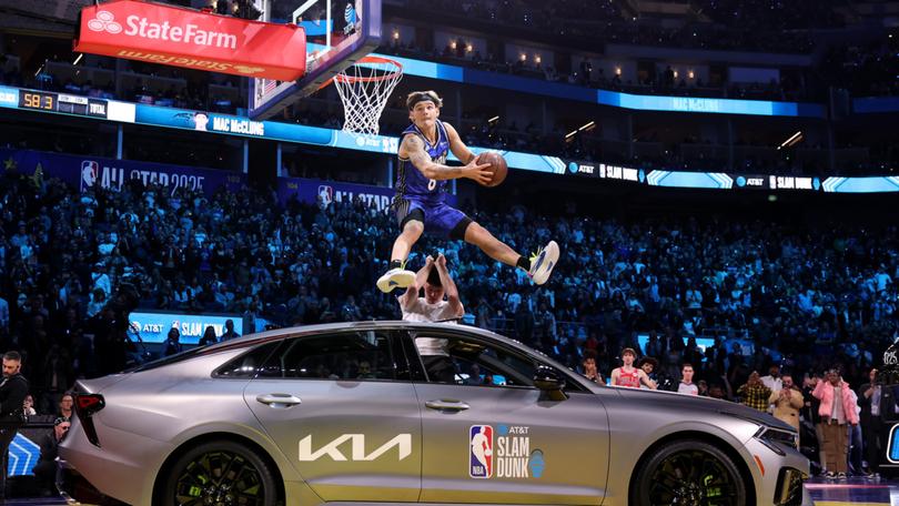 Mac McClung jumps over a car as part of his winning Slam Dunk Contest routine.