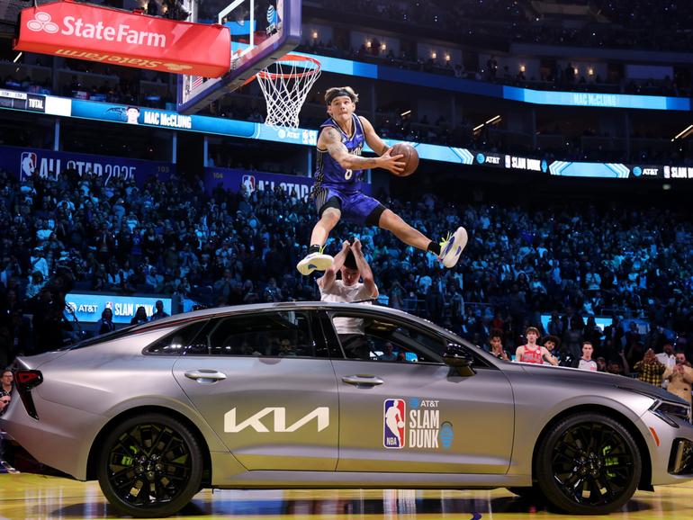 Mac McClung jumps over a car as part of his winning Slam Dunk Contest routine.