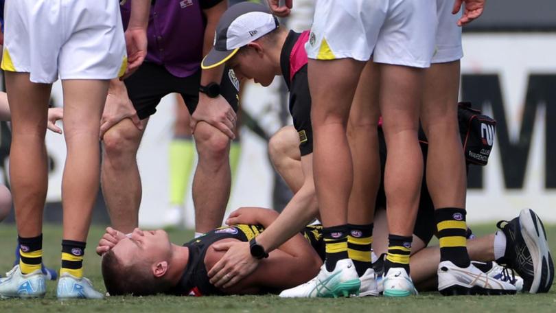 Sam Lalor is attended to by Richmond medical staff during the trial match against West Coast. (Richard Wainwright/AAP PHOTOS)