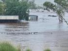 Roads have been cut and properties inundated as floodwaters peak in the aftermath of a cyclone.