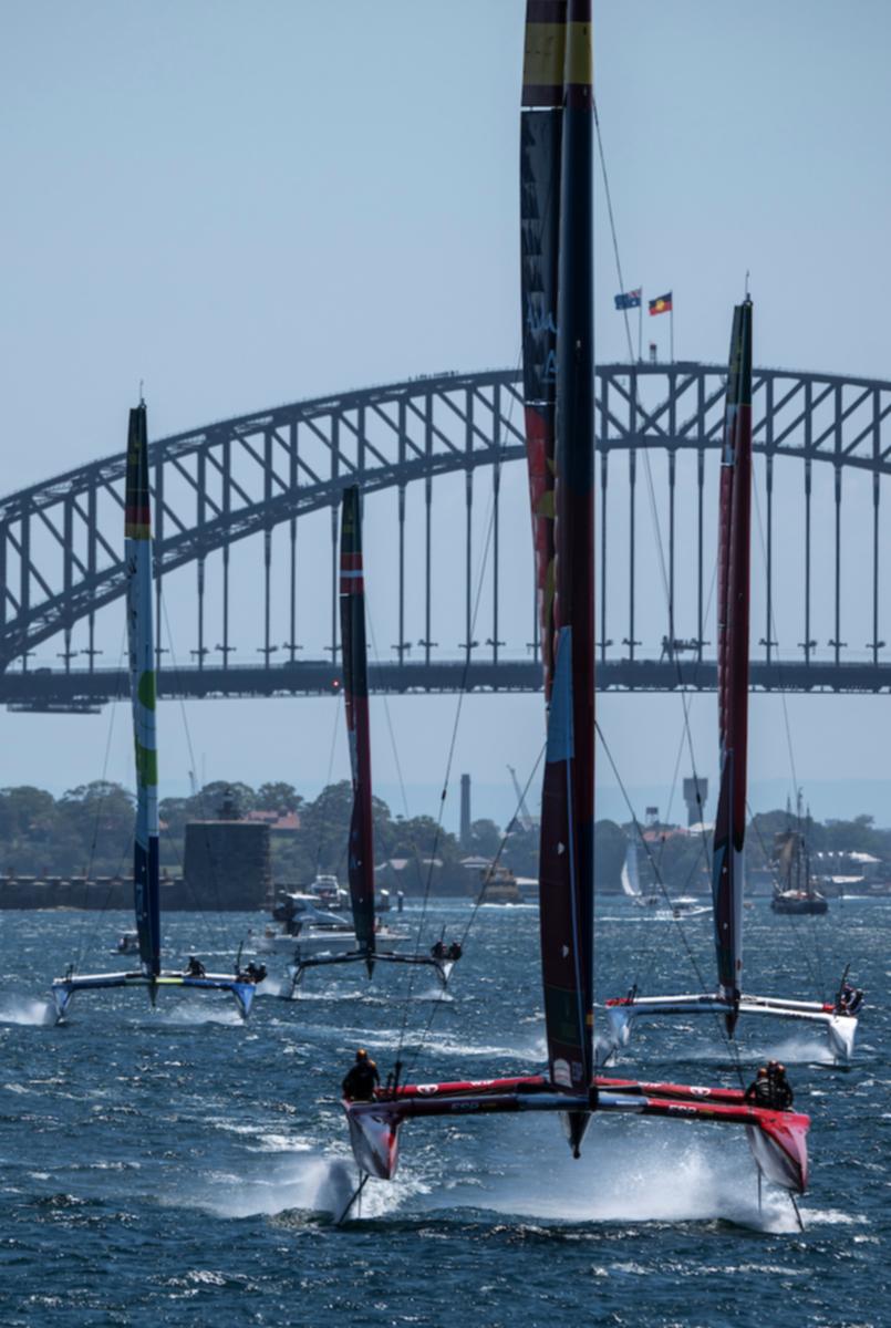 Spain SailGP Team helmed by Diego Botin leads the Canada NorthStar, Mubadala Brazil and New Zealand SailGP teams sailing away from the Sydney Harbour Bridge during the KPMG Australia Sail Grand Prix in Sydney.