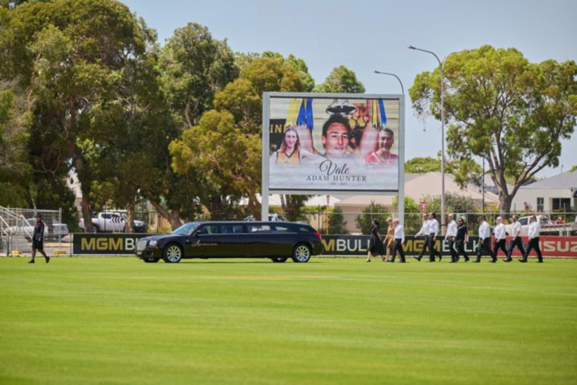 Hunter’s partner Latisha Yacoub, mother Joanne Brown, brother Rod Brown and pallbearers walk with the hearse during the service