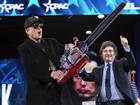 Elon Musk holds up a chainsaw he received from Argentina's President Javier Milei (right) at CPAC. (AP PHOTO)