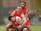 Chad Warner tackles Finn Callaghan during the AFL practice match between Sydney Swans and Greater Western Sydney Giants at Tramway Oval in Sydney today.