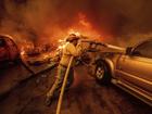 A firefighter battles the Eaton Fire in Altadena. (AP Photo/Ethan Swope)