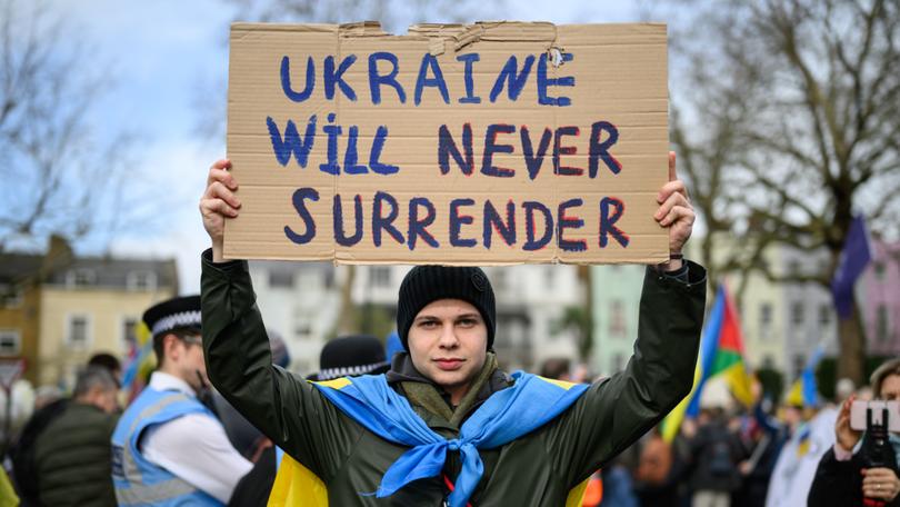 Supporters of Ukraine hold placards as they take part in a march to the Embassy of Russia in London. 