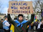 Supporters of Ukraine hold placards as they take part in a march to the Embassy of Russia in London. 