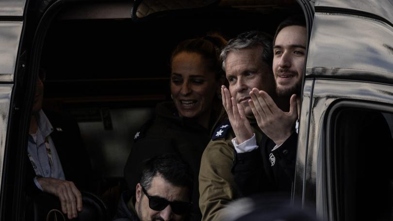 Freed Israeli hostage Omer Shem Tov gestures from a van as he arrives at Beilinson hospital in Petah Tikva, Israel, after he was released from Hamas captivity in the Gaza Strip on Saturday.