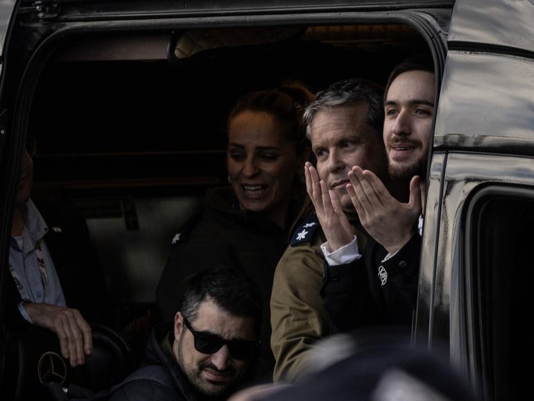 Freed Israeli hostage Omer Shem Tov gestures from a van as he arrives at Beilinson hospital in Petah Tikva, Israel, after he was released from Hamas captivity in the Gaza Strip on Saturday.