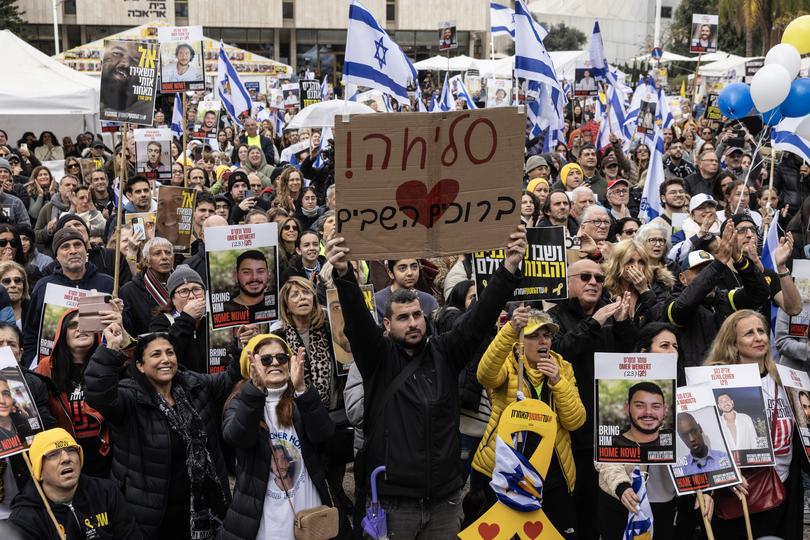 Israelis watch a live broadcast as the first two of six hostages, Avera Mengistu and Tal Shoham, are released in Gaza.