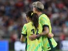 Hayley Raso and Michelle Heyman Australia embrace after being defeated by the United States in the 2025 SheBelieves Cup match in Glendale, Arizona.