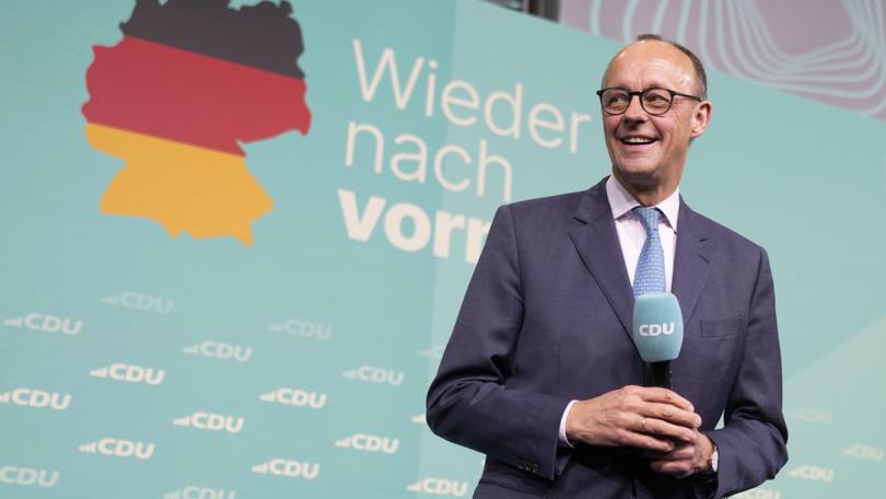 Friedrich Merz, the candidate of the mainstream conservative Christian Democratic Union party, smiles while addressing supporters at the party headquarters in Berlin, Germany.