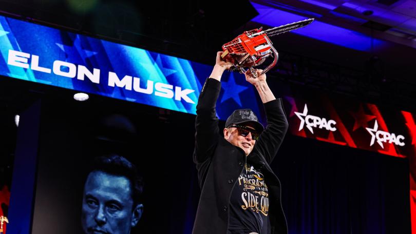 Elon Musk holds a chainsaw given to him by Argentine President Javier Milei at the Conservative Political Action Conference in Maryland on Feb. 20. MUST CREDIT: Valerie Plesch/For The Washington Post 