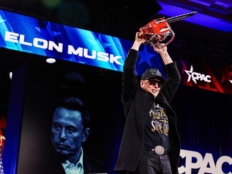 Elon Musk holds a chainsaw given to him by Argentine President Javier Milei at the Conservative Political Action Conference in Maryland on Feb. 20. MUST CREDIT: Valerie Plesch/For The Washington Post 