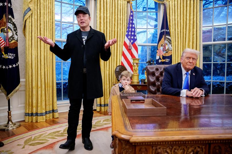 Tesla and SpaceX CEO Elon Musk, accompanied by U.S. President Donald Trump (R), and his son X Musk, speaks during an executive order signing in the Oval Office at the White House on February 11, 2025. 