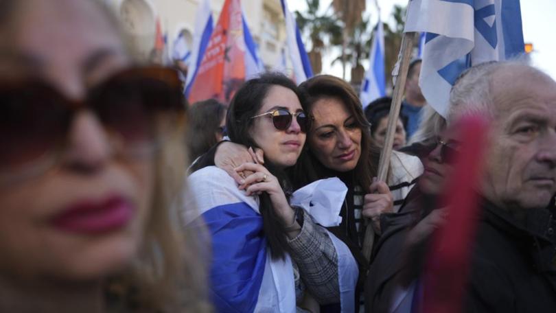 Thousands of people have lined Israeli streets to mourn members of the Bibas family.