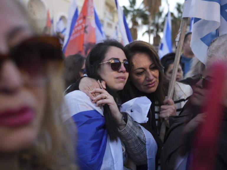 Thousands of people have lined Israeli streets to mourn members of the Bibas family.