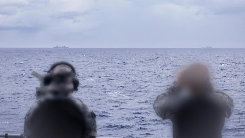 Royal Australian Navy sailors on HMAS Arunta keeping watch on People's Liberation Army-Navy (PLA-N) Fuchi-class replenishment vessel Weishanhu and Jiangkai-class frigate Hengyang in the Tasman Sea. 