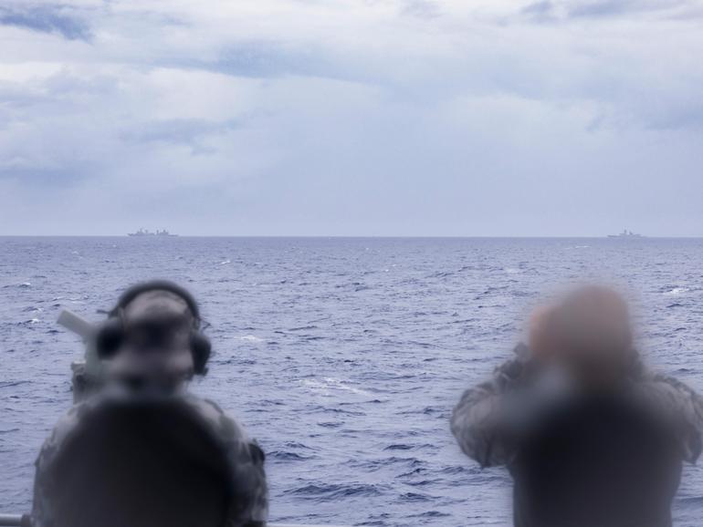 Royal Australian Navy sailors on HMAS Arunta keeping watch on People's Liberation Army-Navy (PLA-N) Fuchi-class replenishment vessel Weishanhu and Jiangkai-class frigate Hengyang in the Tasman Sea. 